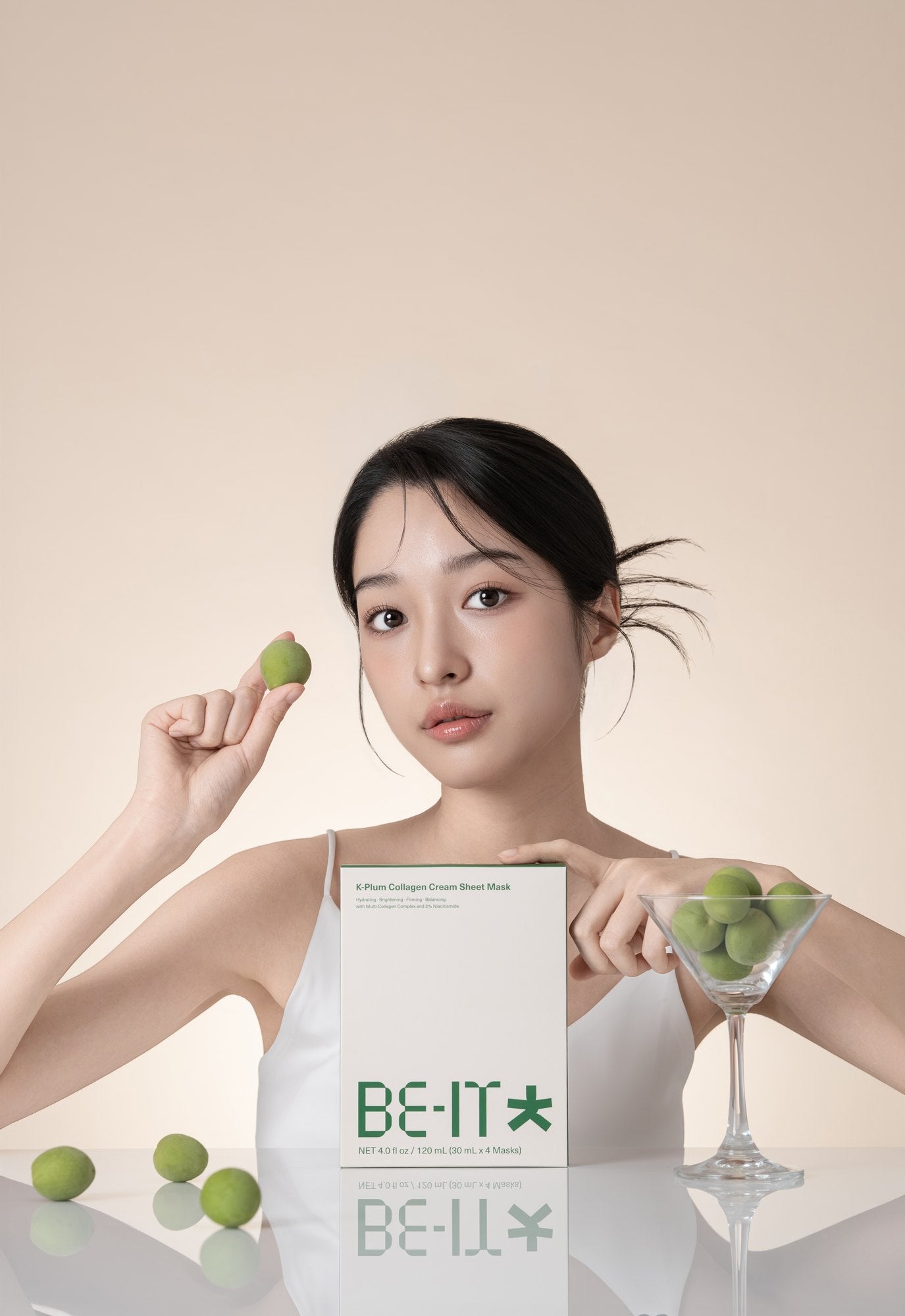 Woman holding BE-IT mask and fresh limes
