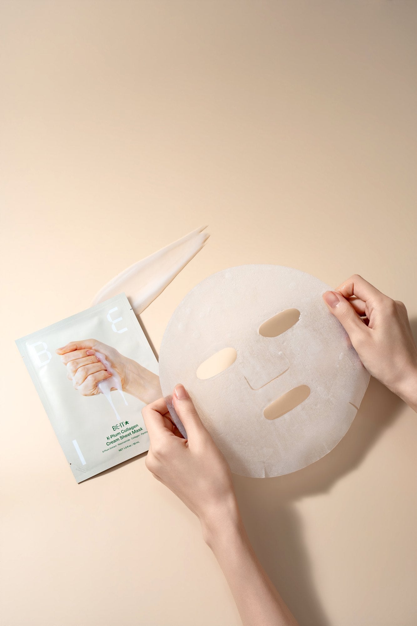 Hands holding a BE-IT sheet mask